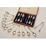 A boxed set of six silver teaspoons with sugar tongs, hallmarks for London 1914-15 CJDF,