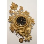 A French gilt wall clock, the black enamel dial with Roman numerals,