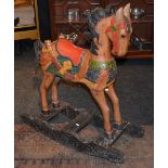 A reproduction painted wood rocking horse,