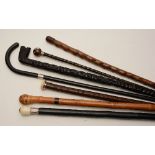 Six assorted walking sticks, to include two carved sticks, one with ivory top, a pipe stick,