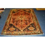 A Qashqai carpet, the central cream diamond over red ground within further diamond,