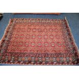 A large Persian style carpet, the allover foliate designs in pink and blue,