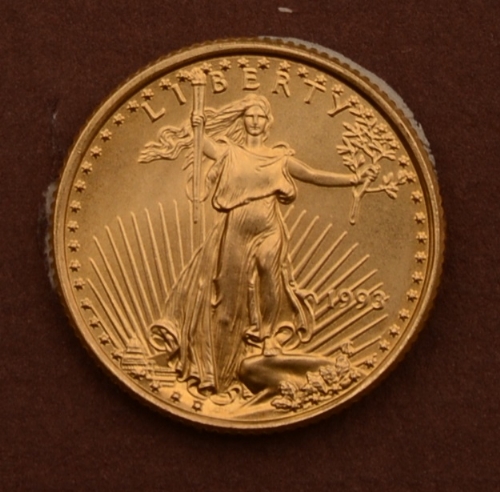 A gold coin from the Strategic Decisions Group, dated 1993 with Liberty to the front, 3.