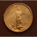 A gold coin from the Strategic Decisions Group, dated 1993 with Liberty to the front, 3.