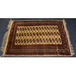 A Hamadan floor rug, decorated with 15 rows of three red, white and blue motifs on gold ground,