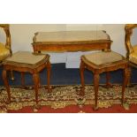 A walnut nest of three tables, raised on cabriole legs with ball and claw supports,