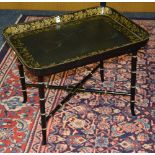 A French style black painted papier mache tray top table, with gilded floral decoration,