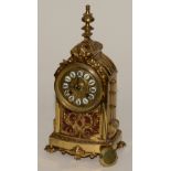 A French brass mantel clock, the dial with enamel Roman numeral indicators,