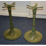 A pair of Art Nouveau green painted cast iron pub table bases,