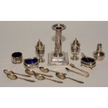 A mixed lot of silver, to include Corinthian style candlesticks, pair of pepper pots, condiments,