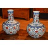 A pair of 20th century large Chinese baluster shaped pottery vases, decorated with blue, red,