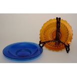 Two Chinese Peking glass circular dishes, in amber and blue colours,
