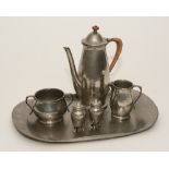 A Liberty & Co Tudric English hammered pewter coffee set on tray, comprising of coffee pot,