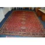 WITHDRAWN - A Qashkai hand woven carpet, decorated with six central motifs on red ground,