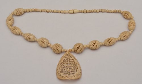 An antique carved bone necklace,