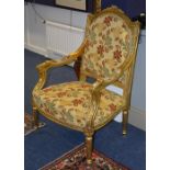 A reproduction Regency style gilt parlour armchair, upholstered in gold floral dralon type fabric,