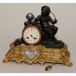 A French gilt mantel clock, depicting Cupid with bow and sevres style panel within gilt base,