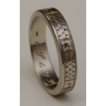An 18ct white gold gents wedding band, with etched decoration allover, 18k stamped to underside,