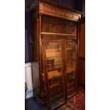 A French style oak bookcase, with two glazed doors enclosing shelved interior, above long drawer,