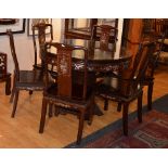 A Chinese Hongmu style hardwood and mother of pearl circular dining table with six chairs,
