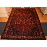 WITHDRAWN - An Iranian floor rug, decorated with large geometric motif on red,