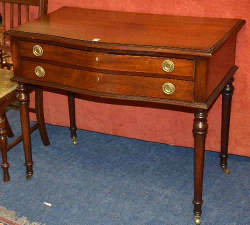 A Regency style mahogany side table, circa 1920's, the serpentine front with two drawers,