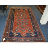 A Kazak rug, the four central blue diamonds over red ground,