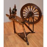 A Beechwood spinning wheel, circa early 20th century, with spindle and bobbin turned decoration,