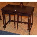 A reproduction nest of three tables, the largest table with card style fold over top,