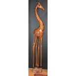 A tall contemporary African wooden figure of a giraffe,