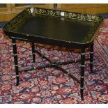 A French style black painted papier mache tray top table, with gilded floral decoration,