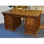 A Continental carved oak partners desk, the top with three drawers to each side,