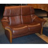 A stressless reclining brown leather two seater sofa by Ekorness,