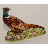 A Beswick figure of a pheasant, painted in rich colours, no1225 stamped to underside,