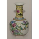 A Chinese famille verte baluster vase decorated with a brightly coloured central floral panel and