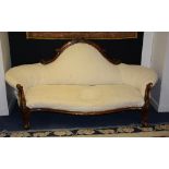 A Victorian scroll back mahogany settee, upholstered in later white fabric,