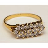 An 18ct gold and diamond dress ring, with 19 brilliant cut diamonds across three rows, approx. 0.