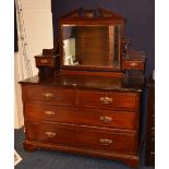 A late Victorian mahogany dressing chest, with swing mirror flanked by a small drawer,