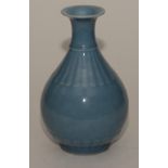 A Chinese pear shaped vase, with ribbed decoration on pale blue ground, Chien Lung marks to base,