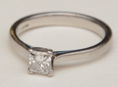 A platinum solitaire diamond ring, the princess cut diamond measuring approx. 0.