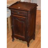 A French oak bedside cabinet, with gallery top above single drawer and panelled door,
