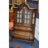 A late 18th/early 19th century Dutch walnut bombe bookcase,