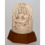 An Indian ivory figure group, probably of a marriage group, raised on wooden base,