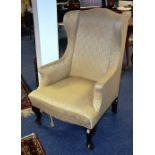 A vintage high back wing armchair circa late 19th/early 20th century,