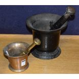 Two pestle and mortars, the larger made from black painted iron, the smaller made from brass,