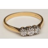 An 18ct gold and platinum three stone diamond ring,