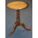 A 19th century oak wine table, the circular top raised on plain column and tripod supports,