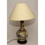 A Chinese famille rose vase converted to table lamp, decorated with panels of figures on white,