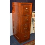 A vintage oak filing cabinet, with four pull out drawers,