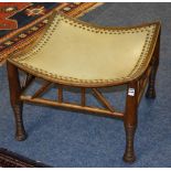 A Liberty & Co salon stool, with studded rexine top, decorated with spindle type columns,